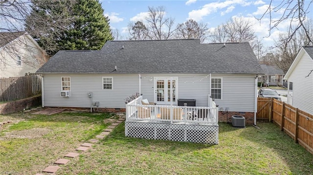 rear view of property with crawl space, a fenced backyard, roof with shingles, and a yard