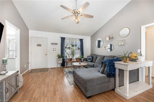 living area with light wood-type flooring, a healthy amount of sunlight, and ceiling fan