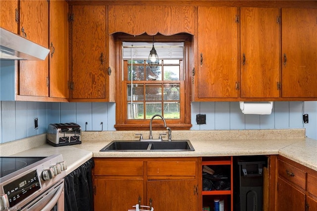 kitchen with a sink, light countertops, under cabinet range hood, and stainless steel electric range