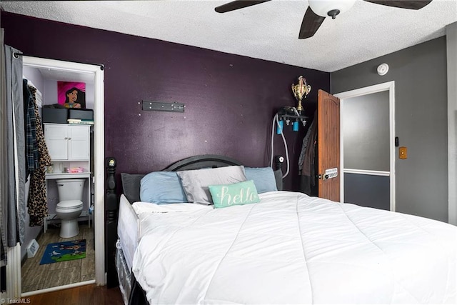 bedroom with a ceiling fan, a textured ceiling, and wood finished floors