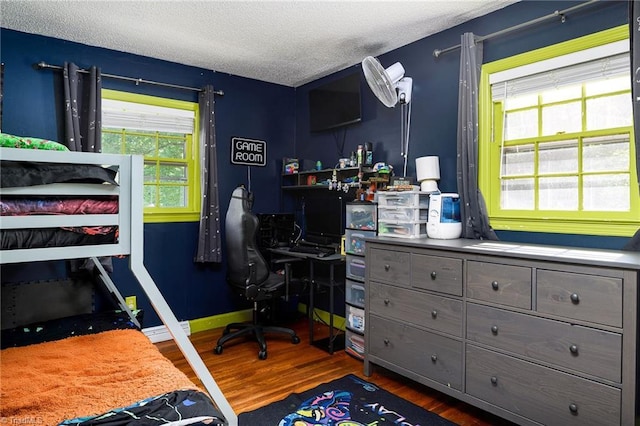 bedroom featuring a textured ceiling and wood finished floors
