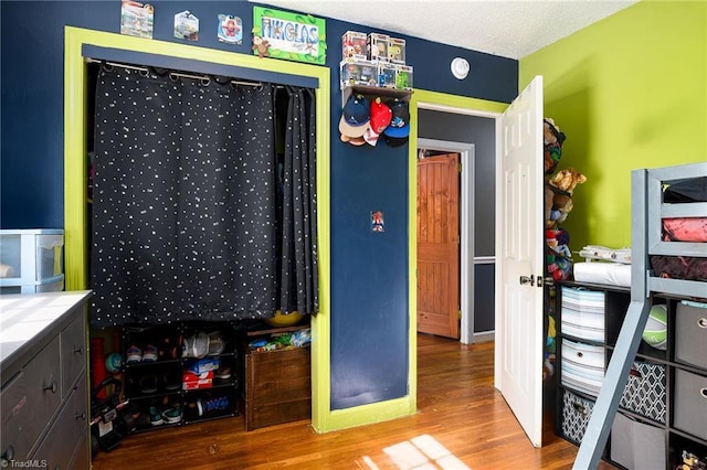 bedroom with wood finished floors