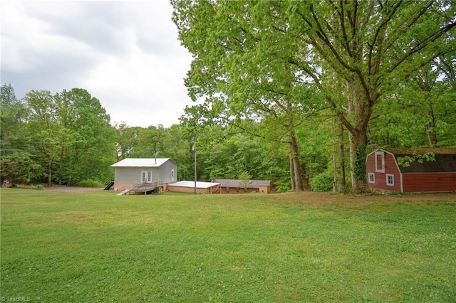 view of yard with an outdoor structure and a deck