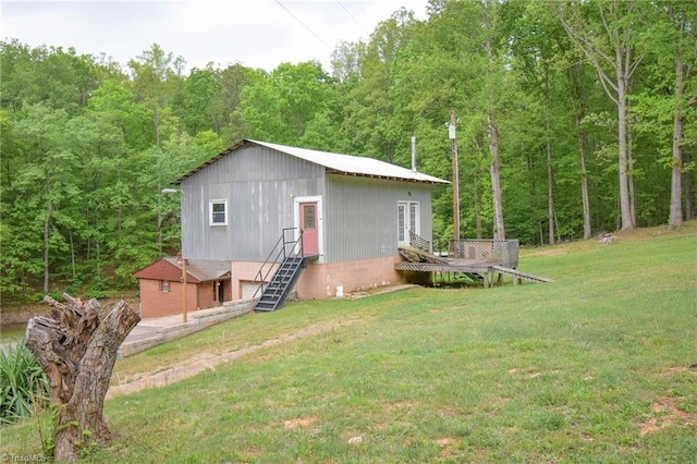 view of outbuilding featuring a garage, a view of trees, and french doors