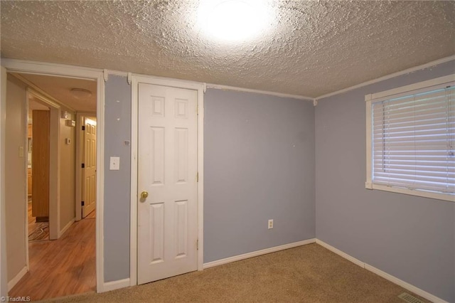 unfurnished room featuring a textured ceiling