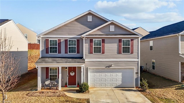 traditional home with a garage, driveway, and a porch