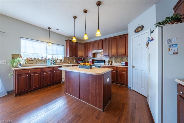 kitchen with decorative backsplash, dark hardwood / wood-style flooring, white appliances, and a center island