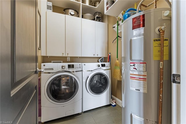 washroom with water heater, cabinets, and separate washer and dryer