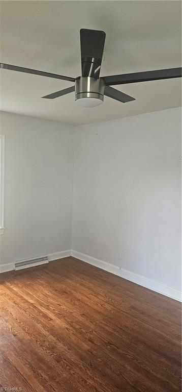 508 Twin Oak Ct, High Point, NC 27260 - empty room with a ceiling fan, a baseboard radiator, dark wood-style floors, and baseboards