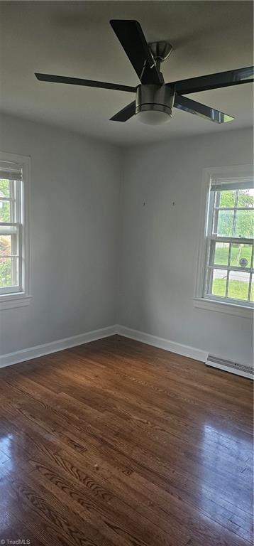 508 Twin Oak Ct, High Point, NC 27260 - spare room with ceiling fan, dark wood-style floors, a baseboard radiator, and baseboards