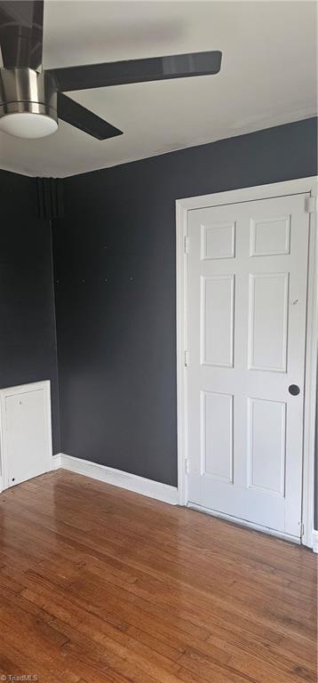 508 Twin Oak Ct, High Point, NC 27260 - unfurnished bedroom with wood finished floors, baseboards, and ceiling fan