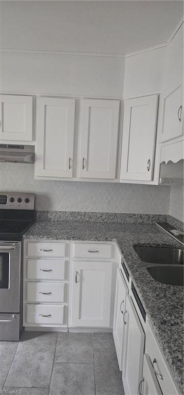 508 Twin Oak Ct, High Point, NC 27260 - kitchen with electric stove, under cabinet range hood, white cabinets, a sink, and light tile patterned floors