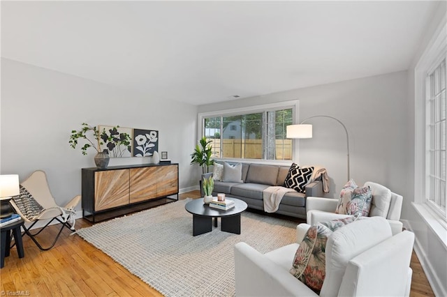 living room with baseboards and light wood-style floors