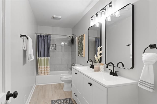 bathroom featuring shower / bath combo, a sink, toilet, and wood finished floors