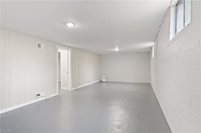 below grade area featuring concrete block wall and visible vents