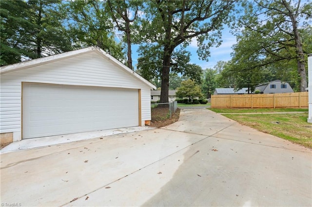 detached garage featuring fence