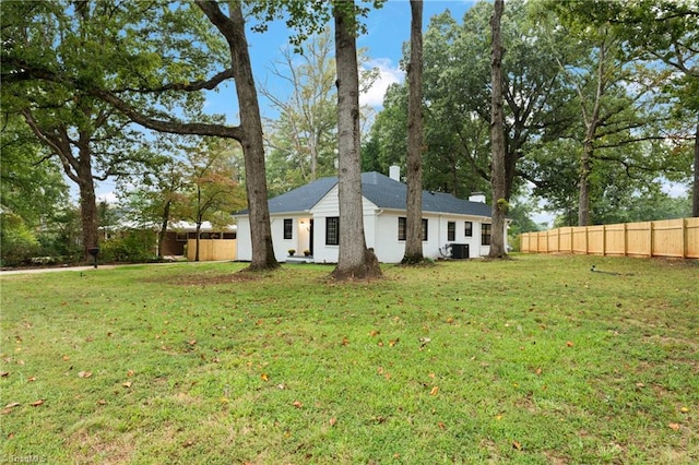 exterior space with a lawn and central air condition unit