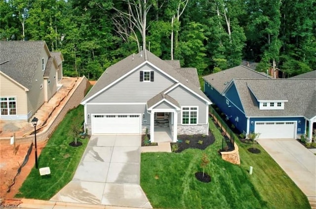 2433 Albemarle Ct, Winston-Salem, NC 27106 - view of front of property featuring concrete driveway, a front yard, a garage, and stone siding