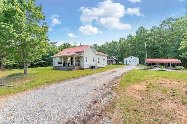 1055 Old Silver Hill Rd, Lexington, NC 27292 - view of front of house with covered porch, an outdoor structure, a front yard, gravel driveway, and metal roof