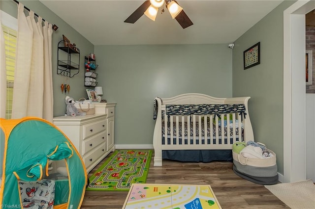 1055 Old Silver Hill Rd, Lexington, NC 27292 - bedroom featuring wood finished floors, baseboards, a ceiling fan, and a nursery area