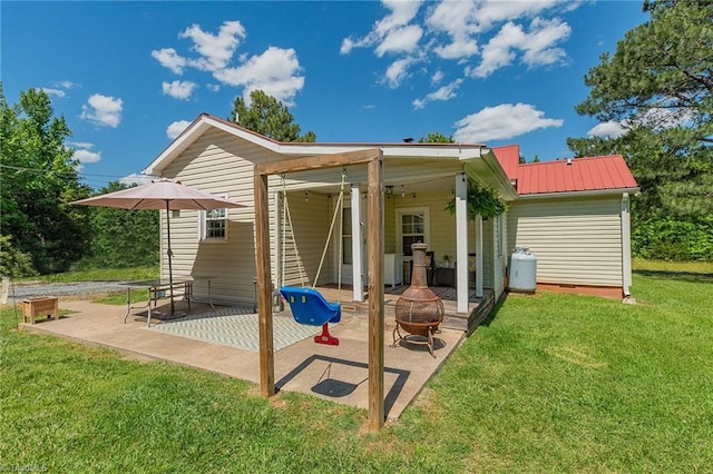 1055 Old Silver Hill Rd, Lexington, NC 27292 - rear view of house with an outdoor fire pit, a patio area, a yard, and metal roof