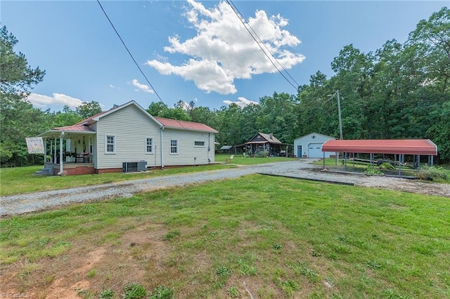 1055 Old Silver Hill Rd, Lexington, NC 27292 - view of grassy yard with a carport, an outdoor structure, central AC unit, and gravel driveway