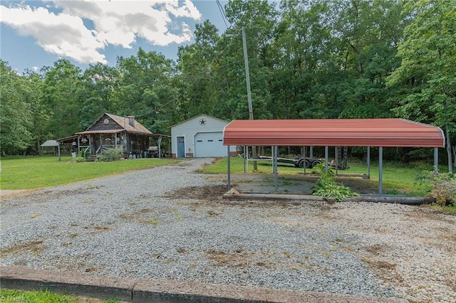 1055 Old Silver Hill Rd, Lexington, NC 27292 - view of front of property featuring driveway, an outbuilding, a front lawn, a detached garage, and a wooded view