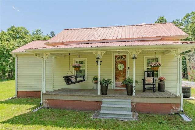 1055 Old Silver Hill Rd, Lexington, NC 27292 - view of front of property with covered porch, a front lawn, central AC unit, and metal roof