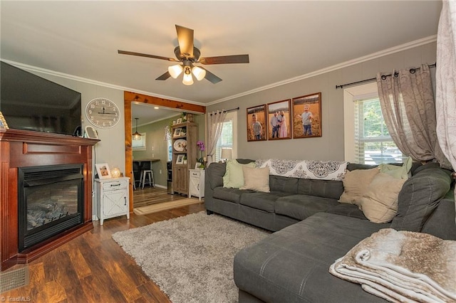 1055 Old Silver Hill Rd, Lexington, NC 27292 - living room featuring healthy amount of natural light, wood finished floors, a ceiling fan, a glass covered fireplace, and ornamental molding