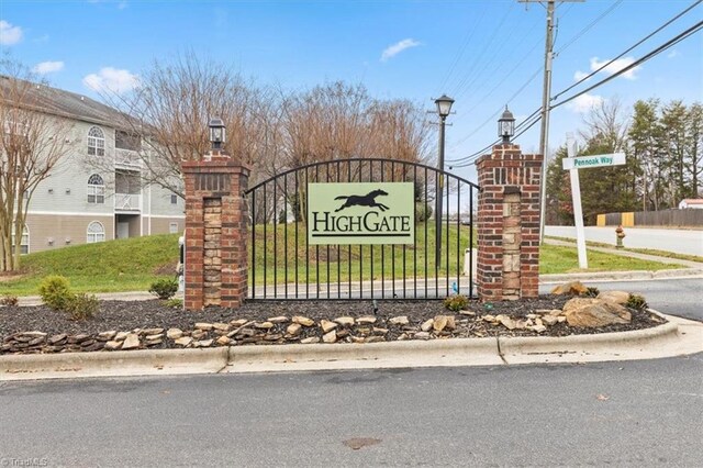 community / neighborhood sign with a lawn