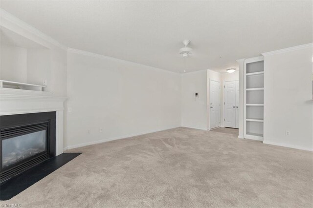 unfurnished living room featuring light carpet, ceiling fan, and ornamental molding