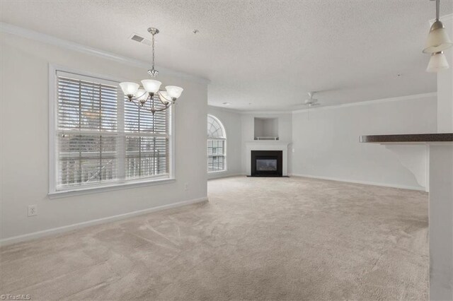 unfurnished living room featuring light carpet, a textured ceiling, ceiling fan with notable chandelier, and ornamental molding