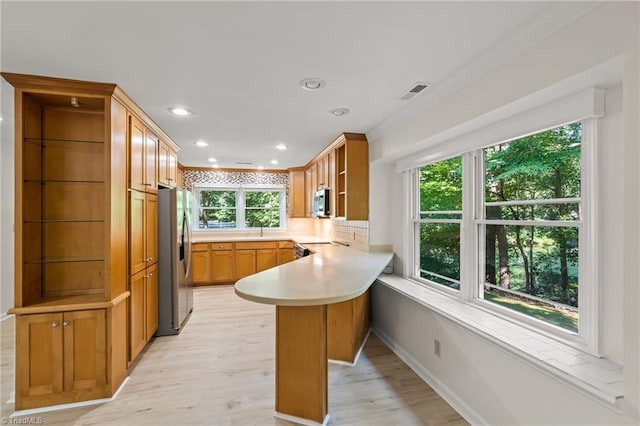 800 Carriage Crossing Ln Unit E, Greensboro, NC 27410 - kitchen with appliances with stainless steel finishes, a peninsula, light wood-style floors, open shelves, and recessed lighting