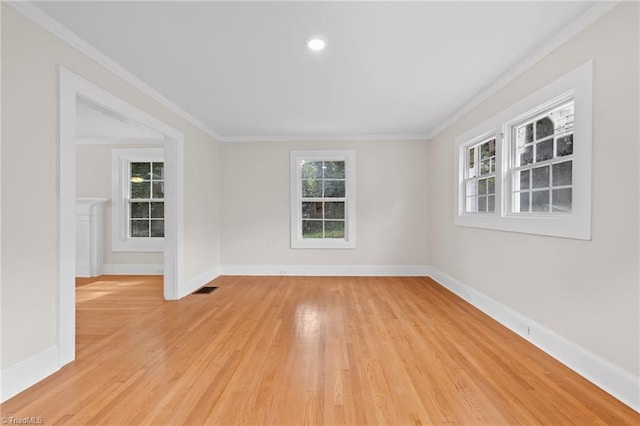 spare room featuring light hardwood / wood-style floors and crown molding