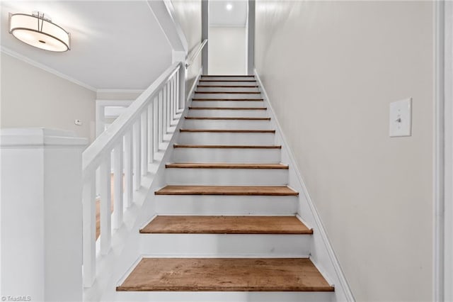 stairway featuring crown molding