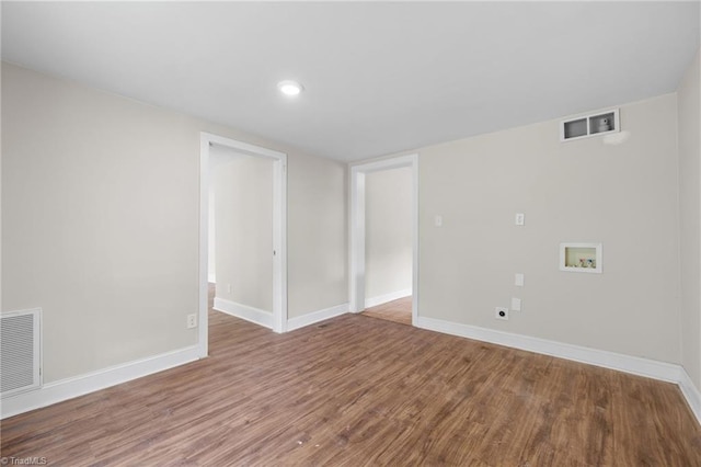 spare room featuring wood-type flooring