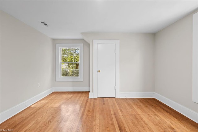 empty room with light hardwood / wood-style flooring