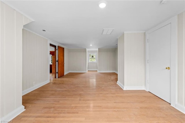 interior space featuring wooden walls and light hardwood / wood-style floors