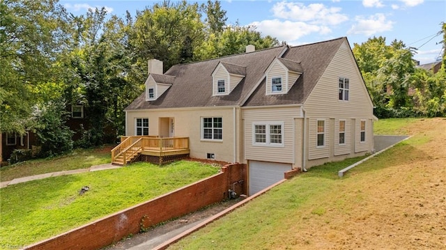 back of house with a garage and a lawn