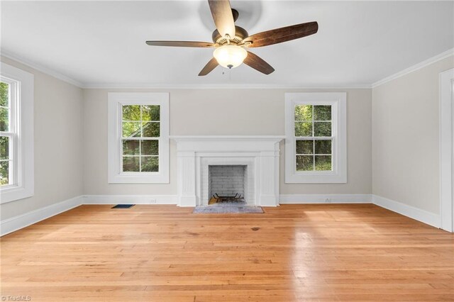 unfurnished living room with crown molding, ceiling fan, and light wood-type flooring