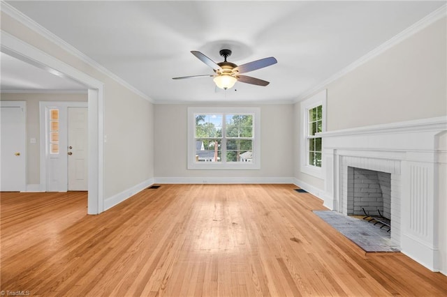 unfurnished living room featuring ceiling fan, ornamental molding, light wood-type flooring, and a fireplace