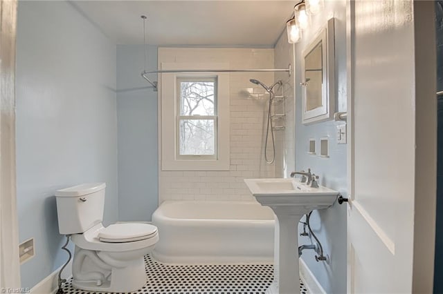 bathroom with tub / shower combination and toilet