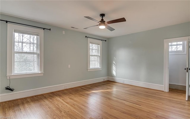 unfurnished room featuring visible vents, baseboards, light wood-style flooring, and a ceiling fan