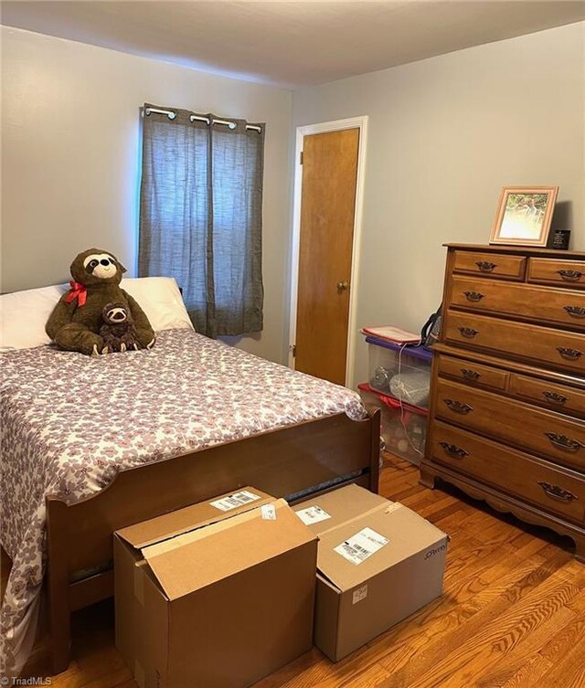 bedroom with hardwood / wood-style floors