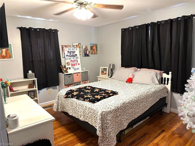 bedroom featuring ceiling fan and dark hardwood / wood-style flooring