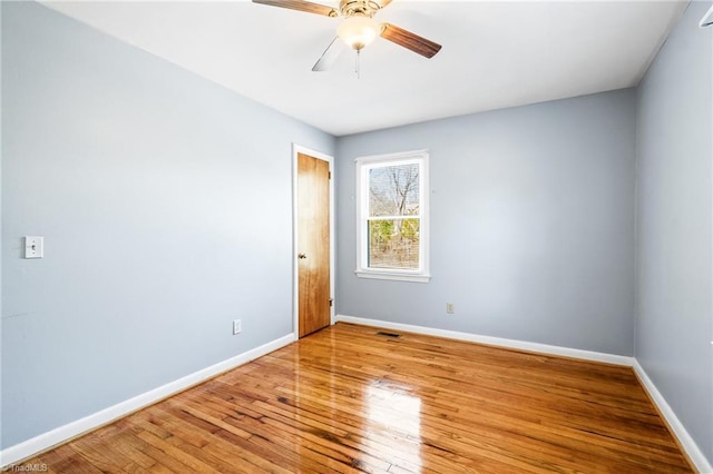 unfurnished room with ceiling fan and hardwood / wood-style floors