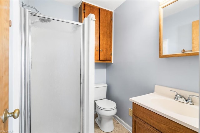 bathroom featuring walk in shower, vanity, toilet, and tile patterned flooring