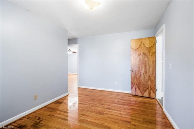 unfurnished room with hardwood / wood-style flooring