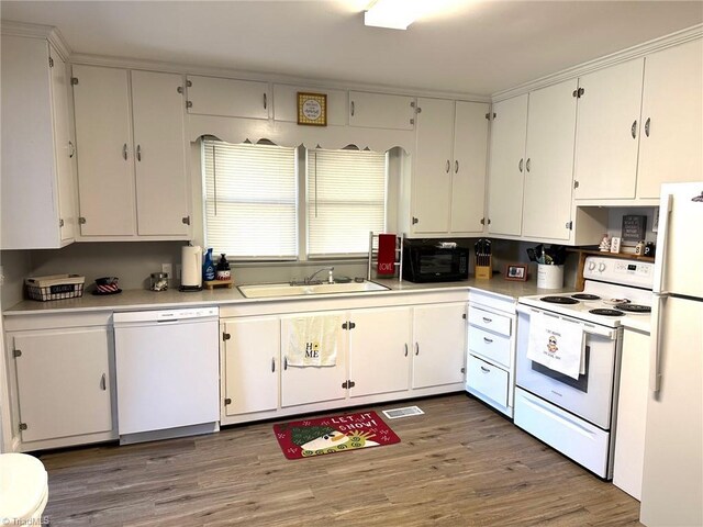 kitchen with white cabinetry, sink, dark wood-type flooring, and white appliances