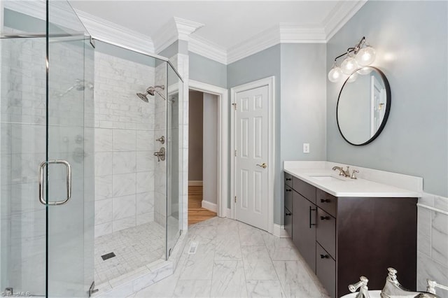 full bathroom with a stall shower, vanity, marble finish flooring, and crown molding